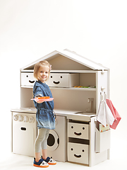 Image showing toddler girl playing with toy kitchen at home