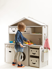 Image showing toddler girl playing with toy kitchen at home