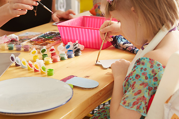 Image showing Cute little girl painting on home interior background