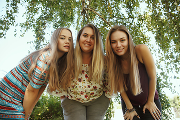 Image showing Happy women outdoors on sunny day. Girl power concept.