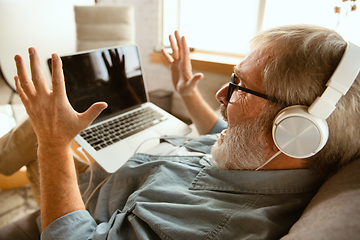 Image showing Senior man working with laptop at home - concept of home studying