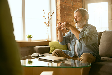 Image showing Senior man working with laptop at home - concept of home studying