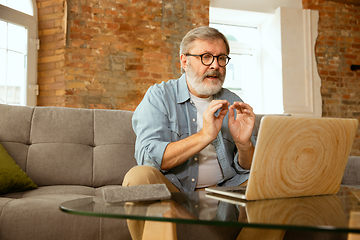 Image showing Senior man working with laptop at home - concept of home studying