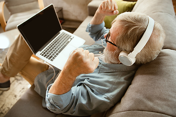 Image showing Senior man working with laptop at home - concept of home studying