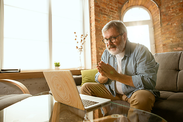 Image showing Senior man working with laptop at home - concept of home studying