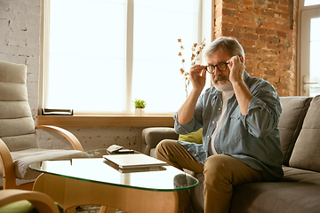 Image showing Senior man working with laptop at home - concept of home studying