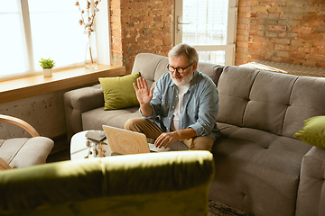 Image showing Senior man working with laptop at home - concept of home studying