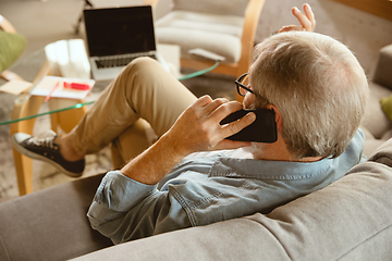 Image showing Senior man working with laptop at home - concept of home studying