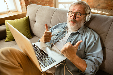 Image showing Senior man working with laptop at home - concept of home studying