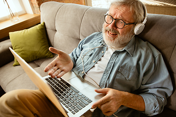 Image showing Senior man working with laptop at home - concept of home studying