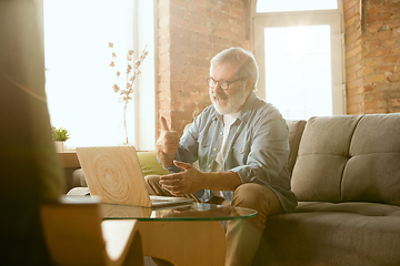 Image showing Senior man working with laptop at home - concept of home studying