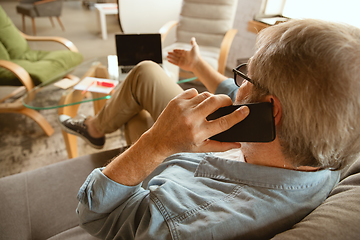 Image showing Senior man working with laptop at home - concept of home studying