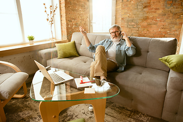 Image showing Senior man working with laptop at home - concept of home studying