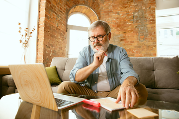 Image showing Senior man working with laptop at home - concept of home studying