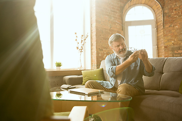 Image showing Senior man working with laptop at home - concept of home studying