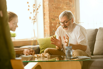 Image showing Senior man doing his wooden constructor at home - concept of home studying