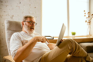 Image showing Senior man working with tablet at home - concept of home studying