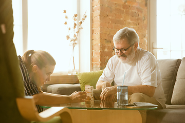 Image showing Senior man doing his wooden constructor at home - concept of home studying