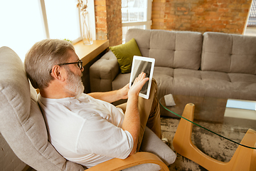 Image showing Senior man working with tablet at home - concept of home studying