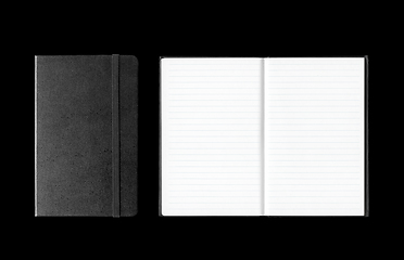 Image showing Closed and open notebooks isolated on black