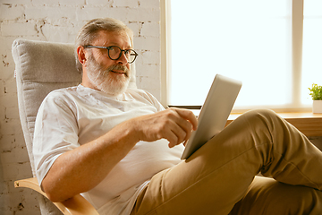 Image showing Senior man working with tablet at home - concept of home studying