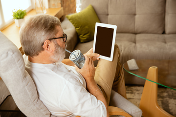 Image showing Senior man working with tablet at home - concept of home studying