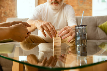 Image showing Senior man doing his wooden constructor at home - concept of home studying