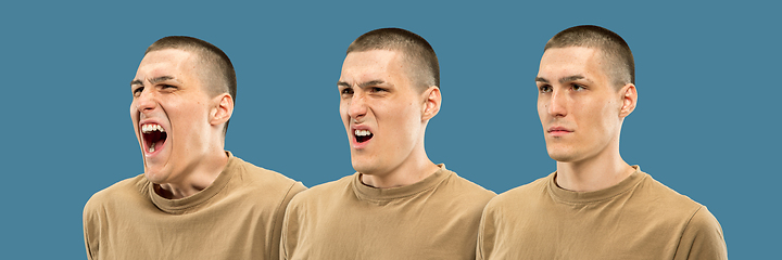 Image showing Caucasian young man\'s half-length portrait on blue background