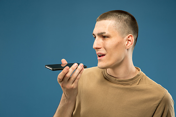 Image showing Caucasian young man\'s half-length portrait on blue background