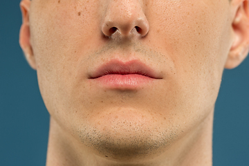 Image showing Caucasian young man\'s close up shot on blue background