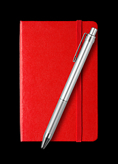 Image showing Red closed notebook and pen isolated on black