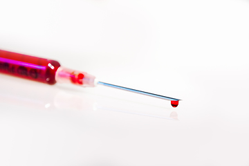 Image showing Syringe with blood on white background