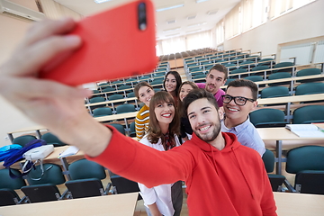 Image showing Group of multiethnic teenagers taking a selfie in school