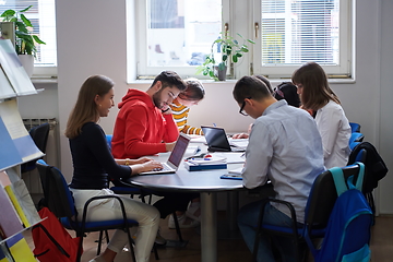 Image showing students group working on school project together on tablet computer at modern university