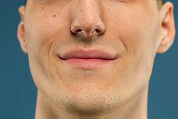 Image showing Caucasian young man\'s close up shot on blue background