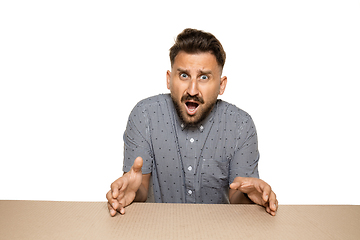 Image showing Shocked and upset man opening the biggest postal package