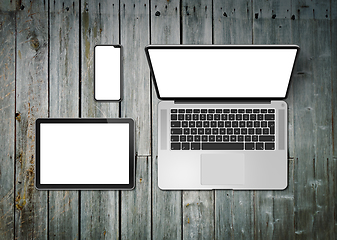 Image showing Laptop, tablet and phone set mockup on a wooden background. 3D r