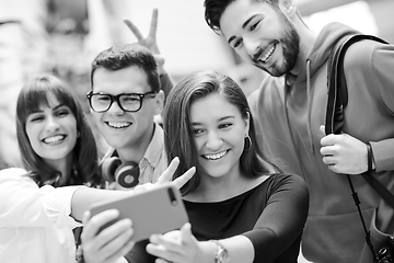 Image showing Group of multiethnic teenagers taking a selfie in school