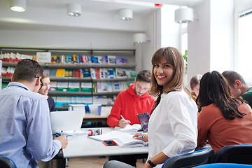 Image showing students group working on school project together on tablet computer at modern university