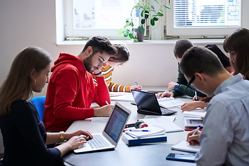 Image showing students group working on school project together on tablet computer at modern university