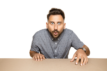 Image showing Shocked man opening the biggest postal package