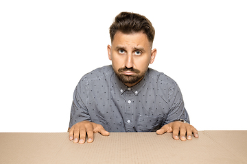 Image showing Shocked and upset man opening the biggest postal package