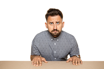 Image showing Shocked and upset man opening the biggest postal package