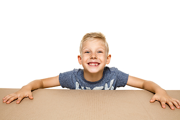 Image showing Cute little boy opening the biggest postal package