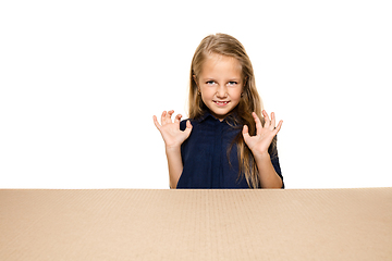 Image showing Cute little girl opening the biggest postal package