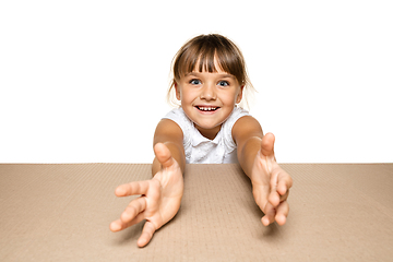 Image showing Cute little girl opening the biggest postal package