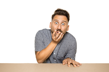 Image showing Shocked man opening the biggest postal package