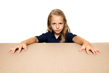 Image showing Cute little girl opening the biggest postal package