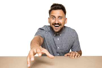 Image showing Shocked man opening the biggest postal package