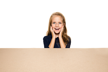 Image showing Cute little girl opening the biggest postal package